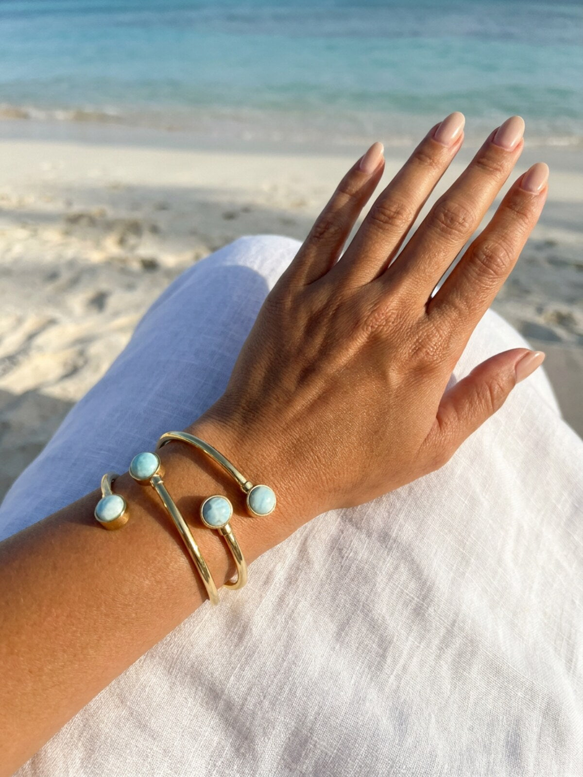 Two larimar bracelets, worn on the wrist on the beach