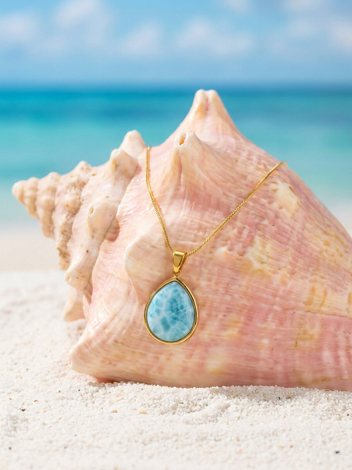 Larimar teardrop necklace, photographed on the beach