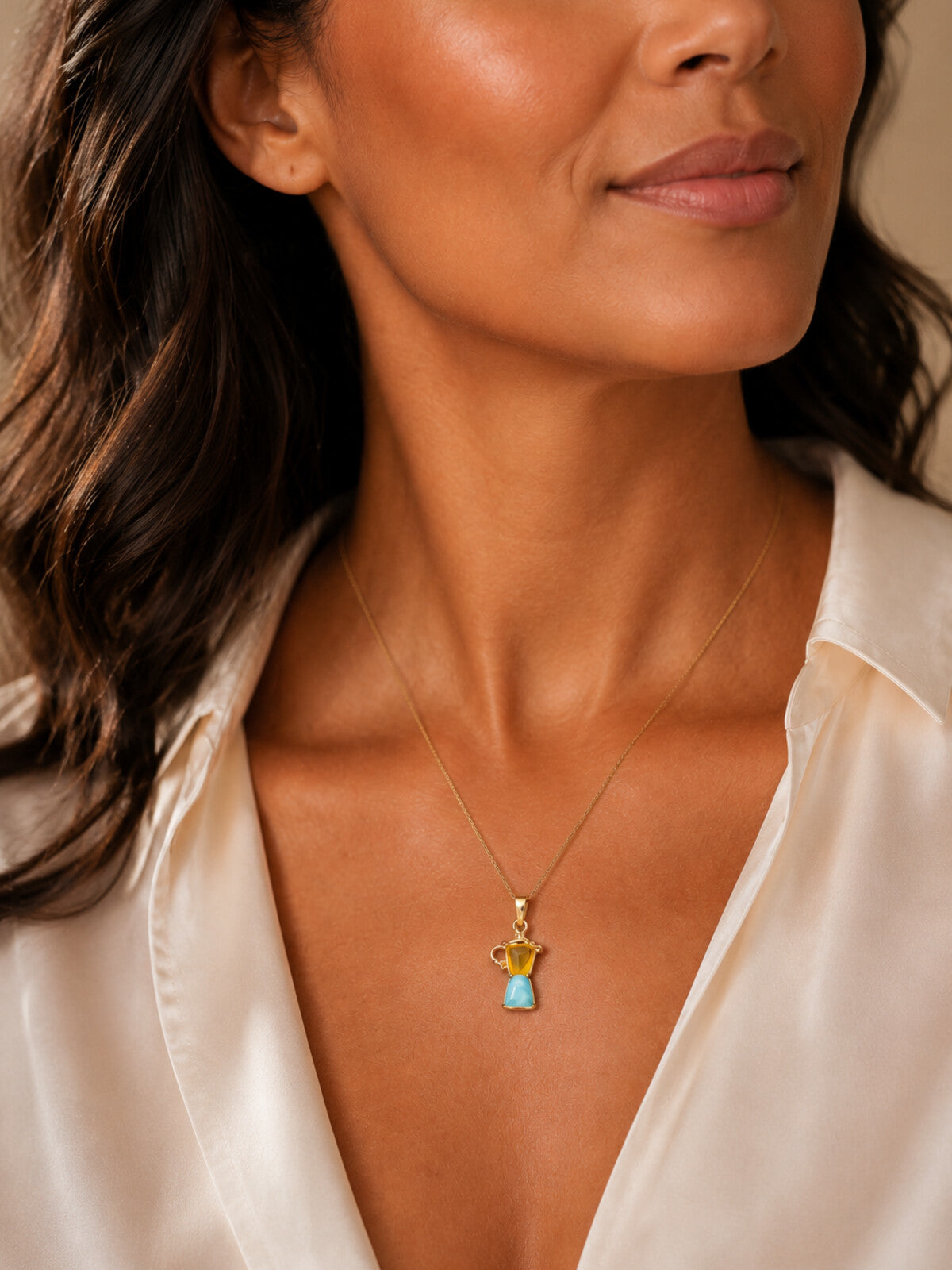 Larimar and amber coffee pot necklace, worn by a model