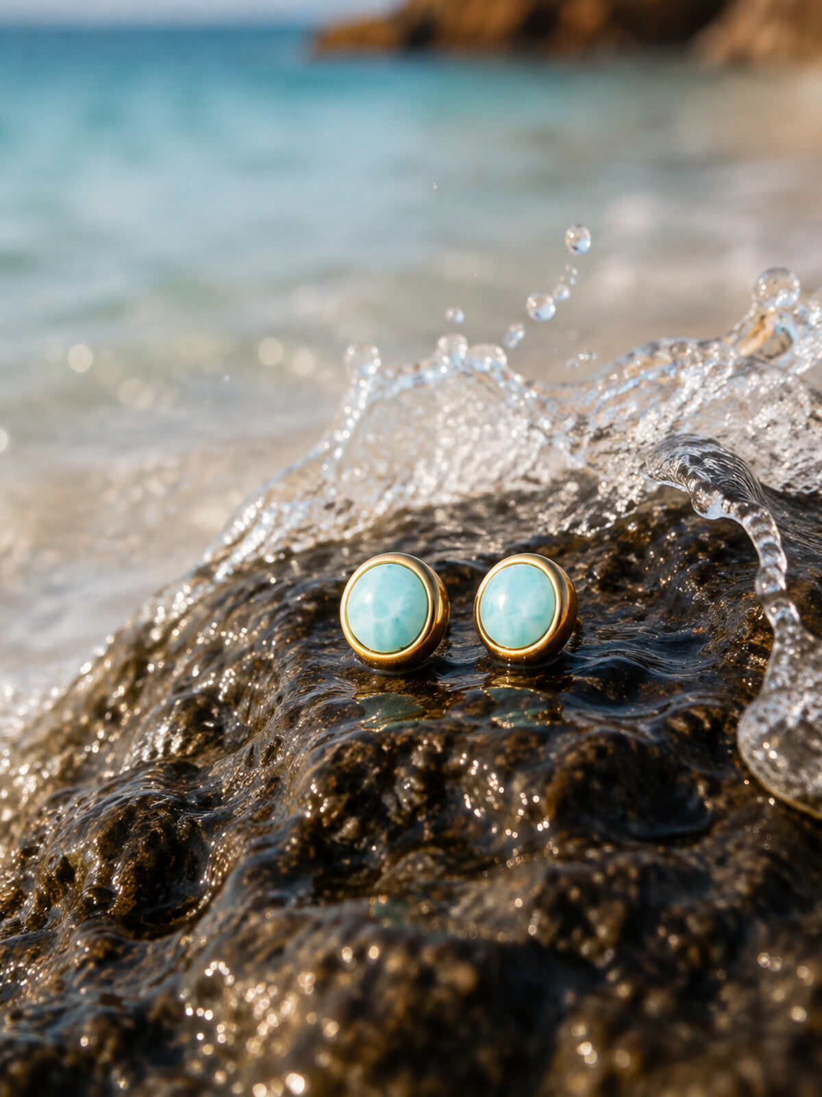 Larimar stud earrings 8mm, photographed on the beach